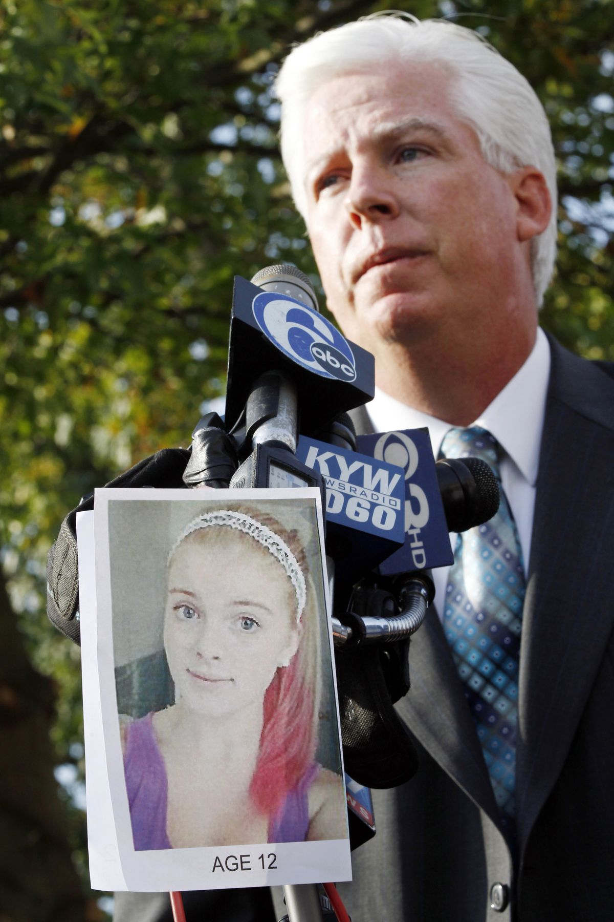 A photograph of Autumn Pasquale is seen as Gloucester County Prosecutor Sean Dalton addresses a gathering outside town hall Tuesday, Oct. 23, 2012, in Clayton, N.J., not far from where a body preliminarily identified as the missing 12-year-old girl
