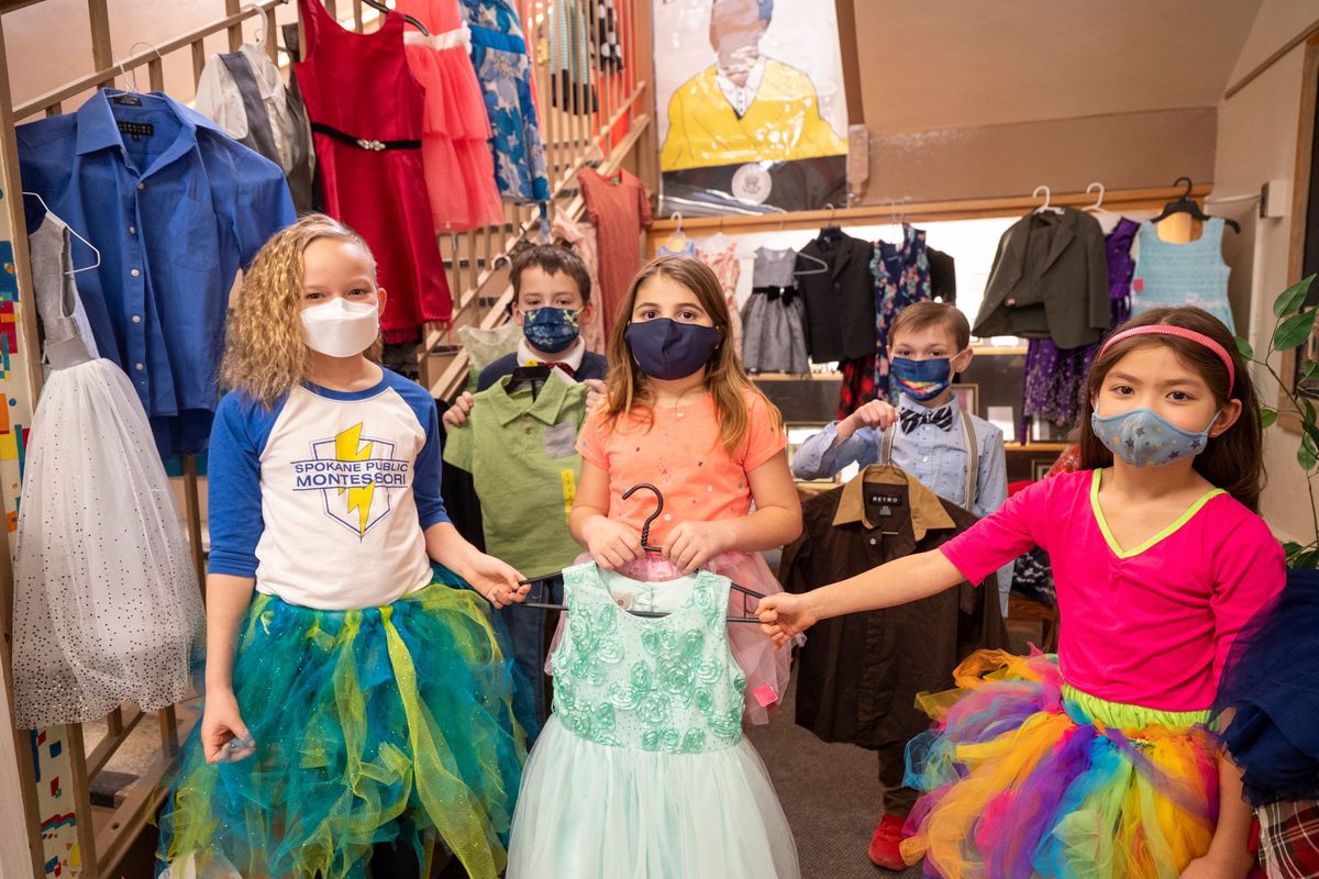 From left, Amelia Prime, Henry Beu, Emmarie Mauk, Eli Cox and Kylie Aoyagi stand with some of the clothing donated for Kid and Teen Closet Tuesday, Feb. 22, 2022 at Spokane Public Montessori school in Spokane, Washington. Kids at the school were asked to dress up, with girls wearing tutus, and make donations to Kid and Teen Closet to honor Madilyn and Molly Baroni, Montessori students who died in a car crash with their dad in 2015.  (Jesse Tinsley/THE SPOKESMAN-REVIEW)