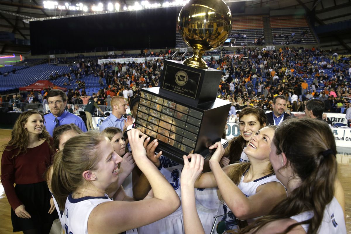 Gonzaga Prep players lift the trophy after they defeated Inglemoor 57-52 in 2OT to win girls’ 4A title in Tacoma. (Associated Press)