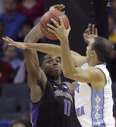 North Carolina’s Kendall Marshall shoots as UW’s Matthew Bryan- Amaning defends during the second half. (Associated Press)