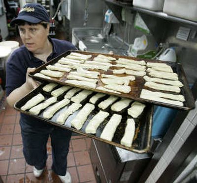 
Mary Hellers prepares to bake breadsticks at a Buddy's Pizza in Detroit. Most pizza makers in the $30 billion-plus industry are struggling with rising prices for ingredients.Associated Press photos
 (Associated Press photos / The Spokesman-Review)