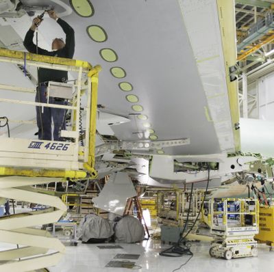 A Boeing Co. employee works on a wing of a Boeing 767 airplane at Boeing Co.'s 767 assembly plant, in Everett, in the file photo from 2011. (Ted S. Warren / AP)