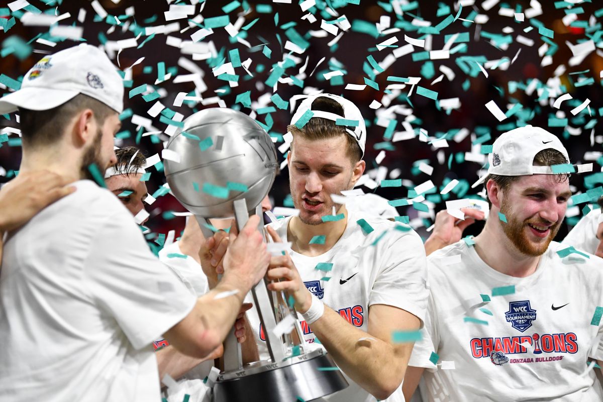 Gonzaga forward Filip Petrusev, center, celebrates with teammate forward Killian Tillie as confetti rains down after the Bulldogs won the West Coast Conference championship in 2020. The NCAA Tournament was canceled just days later.  (TYLER TJOMSLAND)