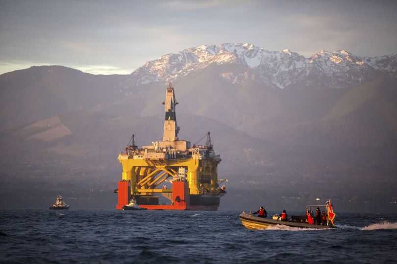 FILE - In this April 17, 2015 file photo, with the Olympic Mountains in the background, a small boat crosses in front of an oil drilling rig as it arrives in Port Angeles, Wash. aboard a transport ship after traveling across the Pacific. Royal Dutch Shell hopes to use the rig for exploratory drilling during the summer open-water season in the Chukchi Sea off Alaska's northwest coast, if it can get the permits. Royal Dutch Shell cleared a major hurdle Monday, May 11, 2015, when The Bureau of Ocean Energy Management approved Shell's exploration plan. However, this isn't the final step that Shell needs for Arctic drilling.  (Daniella Beccaria / Seattlepi.com)