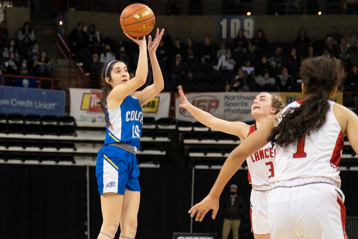 Colfax guard Jaisha Gibb (10) shoots over Liberty defenders during the first half of a State 2B girls semifinal game on Friday, March 4, 2022, at the Spokane Arena.  (Madison McCord/For The Spokesman-Review)