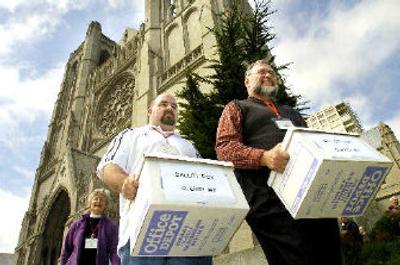 
Election workers carry ballot boxes following voting in the Episcopal Diocese of California earlier this month in San Francisco, where three openly gay clerics unsuccessfully sought election as bishop. 
 (File Associated Press / The Spokesman-Review)