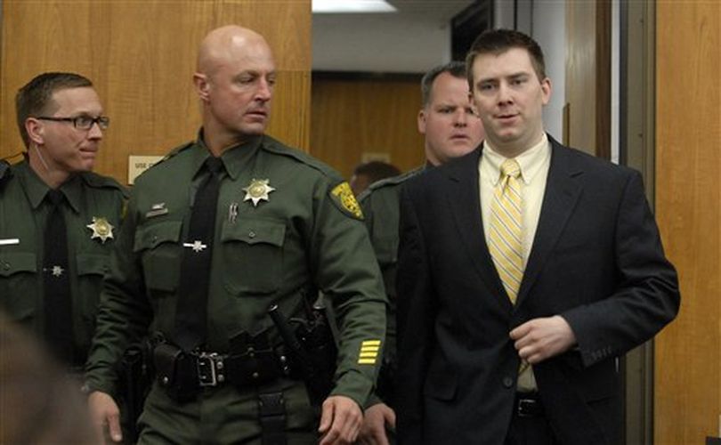 James Biela smiles as he enters the courtroom after lunch Monday May 24, 2010 escorted by Washoe County deputies John Saybo, Scott Thomas and Dan Wheeler on Monday May 24, 2010. Biela  is on trial for the 2008 rape and murder of Brianna Denison. (AP Photo/The Gazette-Journal, Marilyn Newton) (Marilyn Newton / The Gazette-Journal, Marlyn Newton)