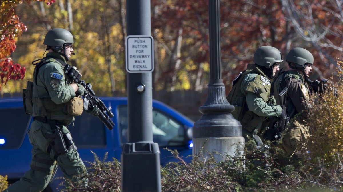Police and swat team members respond to a call of a shooting at the Azana Spa in Brookfield, Wis. Sunday , Oct. 21, 2012.  Multiple people were wounded when someone opened fire at the spa near the Brookfield Square Mall. Deputies are still looking for the gunman. (Tom Lynn / Fr170717 Ap)
