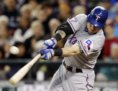Texas' Josh Hamilton lashes an RBI double in the third inning Tuesday against Seattle. (Associated Press)