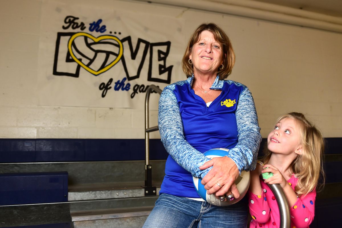 Veteran volleyball coach Sue Doering, with granddaughter Emma Dorman, 4, is finishing 29 years with the Colfax Bulldogs. (Jesse Tinsley / The Spokesman-Review)
