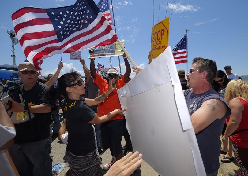 Demonstrators from opposing sides confront each other Friday outside a U.S. Border Patrol station in Murrieta, Calif. (Associated Press)