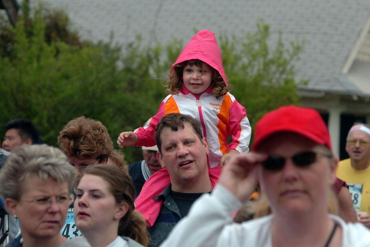 Bailey Wilks, 3, rides most of Bloomsday on the shoulders of her father, Brian Wilks during Bloomsday 2006. (Jesse Tinsley / The Spokesman-Review)