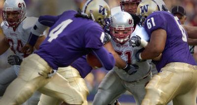 
WSU linebacker Will Derting fights through a double team as he eyes UW quarterback Isaiah Stanback. Derting, who missed much of the season with a knee injury, played all but one series was jubilant after the Apple Cup victory. 
 (Christopher Anderson/ / The Spokesman-Review)
