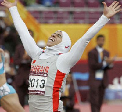 
Bahrain's Ruqaya Al Ghasara celebrates her victory in the 200 meters at the Asian Games in Doha, Qatar, Monday. 
 (Associated Press / The Spokesman-Review)