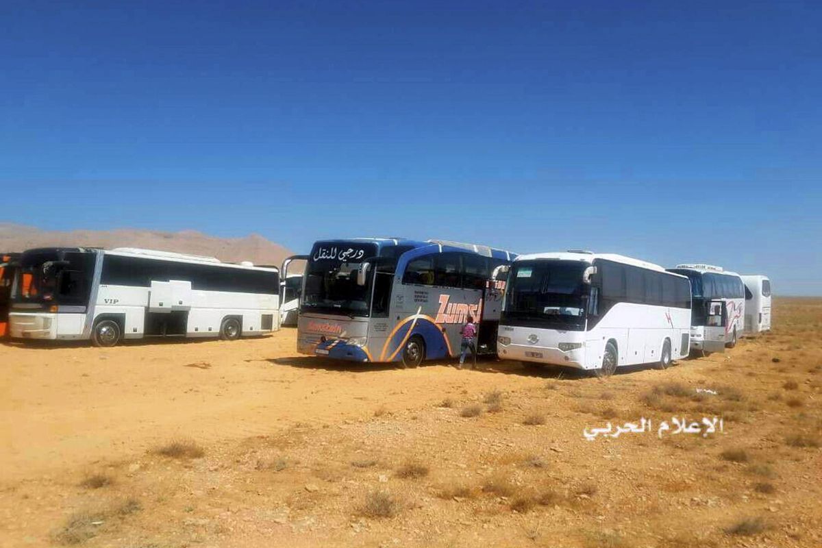 This file photo provided on Monday, Aug 28, 2017, by the government-controlled Syrian Central Military Media shows buses gathering before a planned evacuation of Islamic State group militants, in the mountainous region of Qalamoun, Syria. Islamic State militants, routed from one urban stronghold after another in Syria, have recently been moving deeper into Syrias remote desert, where experts say they are regrouping and preparing their next incarnation. (Syrian Central Military Media via Associated Press)