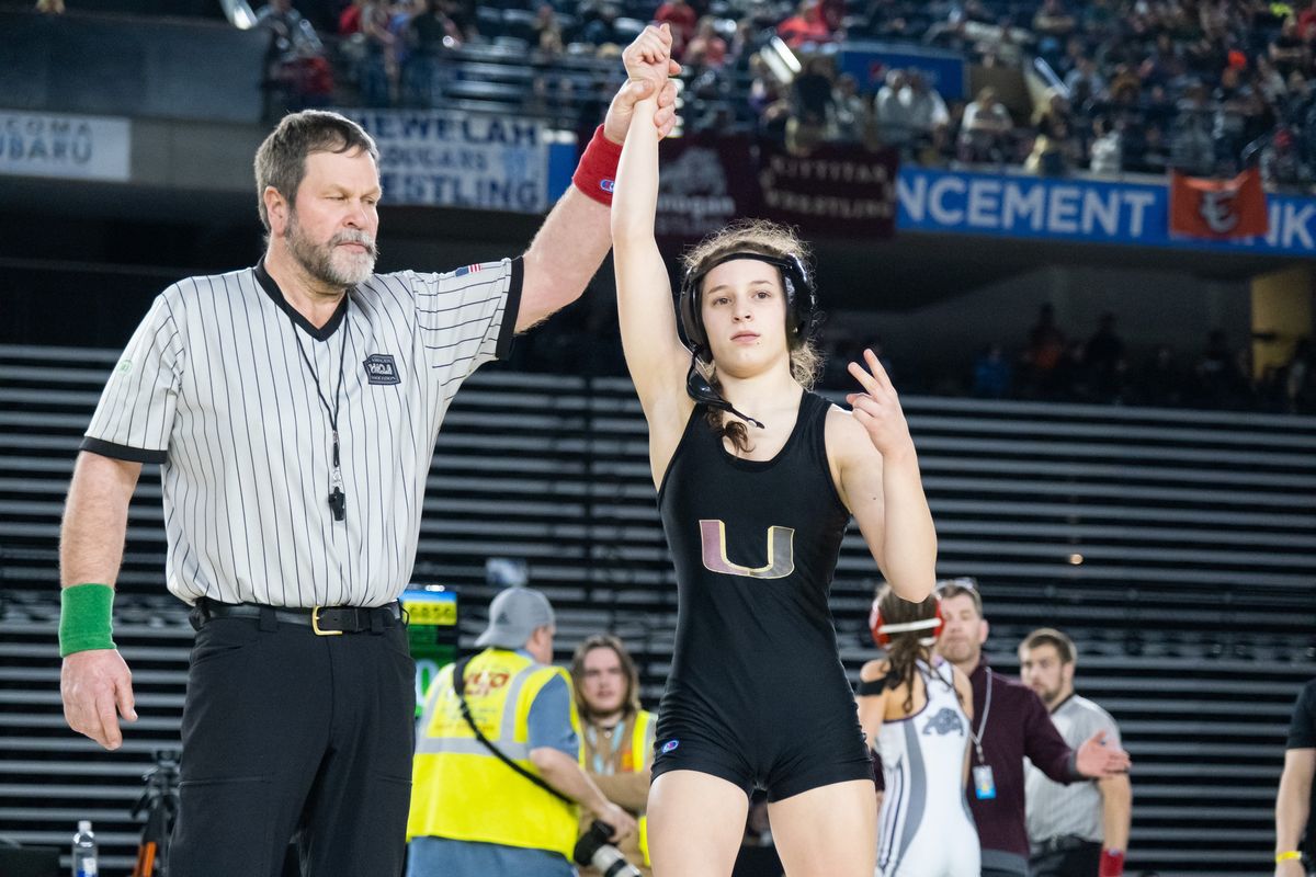 University’s Libby Roberts celebrates after winning the 105-pound 3A/4A girls title at Mat Classic XXXIV Saturday.  (Madison McCord / The Spokesman-Review)