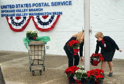 
U.S. Postal Service workers get ready for Thursday's name- changing ceremony at the Spokane Valley Branch Post Office. 
 (Liz Kishimoto / The Spokesman-Review)