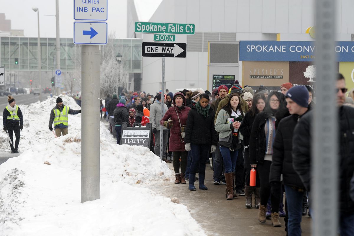 Hundreds wait in line on Spokane Falls Boulevard to get into the Spokane Convention Center for the Martin Luther King Jr. Day march Monday, Jan. 16, 2016. Security had metal detectors set up, causing a slowdown in entry to the building. (Jesse Tinsley / The Spokesman-Review)