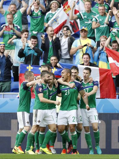 Northern Ireland's players celebrate after eliminating Ukraine 2-0. (Laurent Cipriani / Associated Press)
