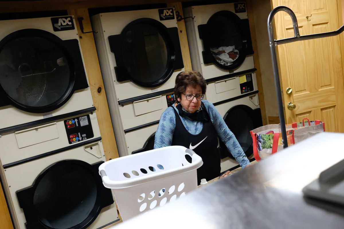 Beverly Nieves, who until recently had never used a laundromat, pauses while doing her laundry at 1 a.m. Friday at Pine Near RV Park in Winthrop, Wash.  (Tyler Tjomsland/The Spokesman-Review)