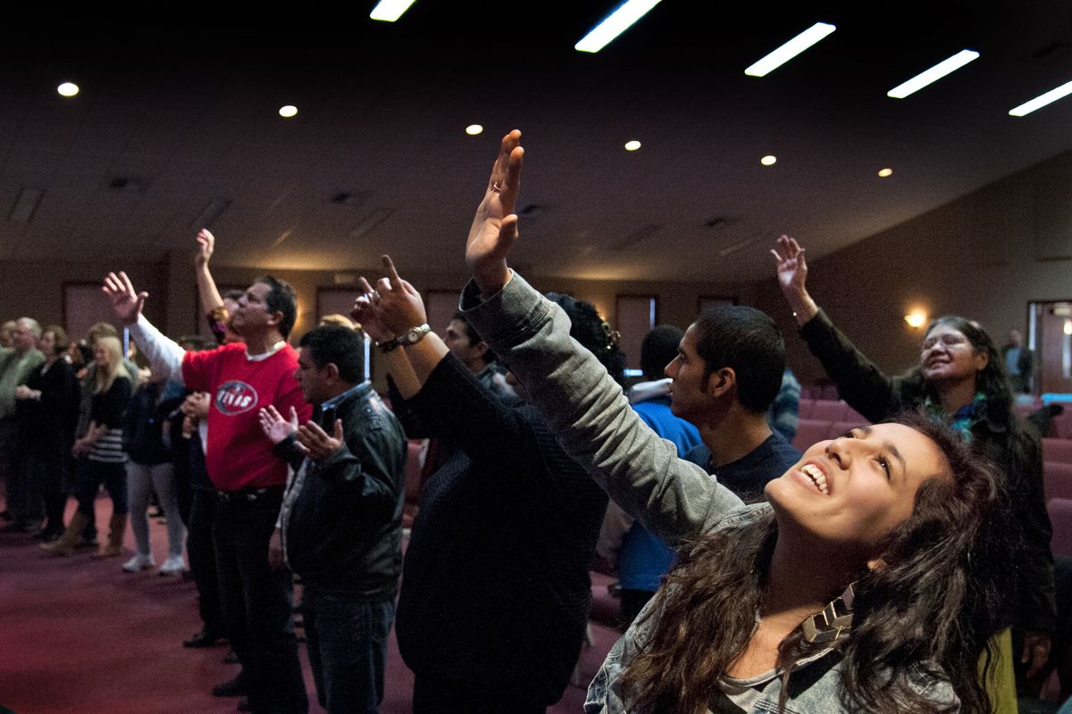 Abi Lopez gives praise during the Church of God of Prophecy’s Spanish service at the Intersection building in Spokane Valley. (Dan Pelle)