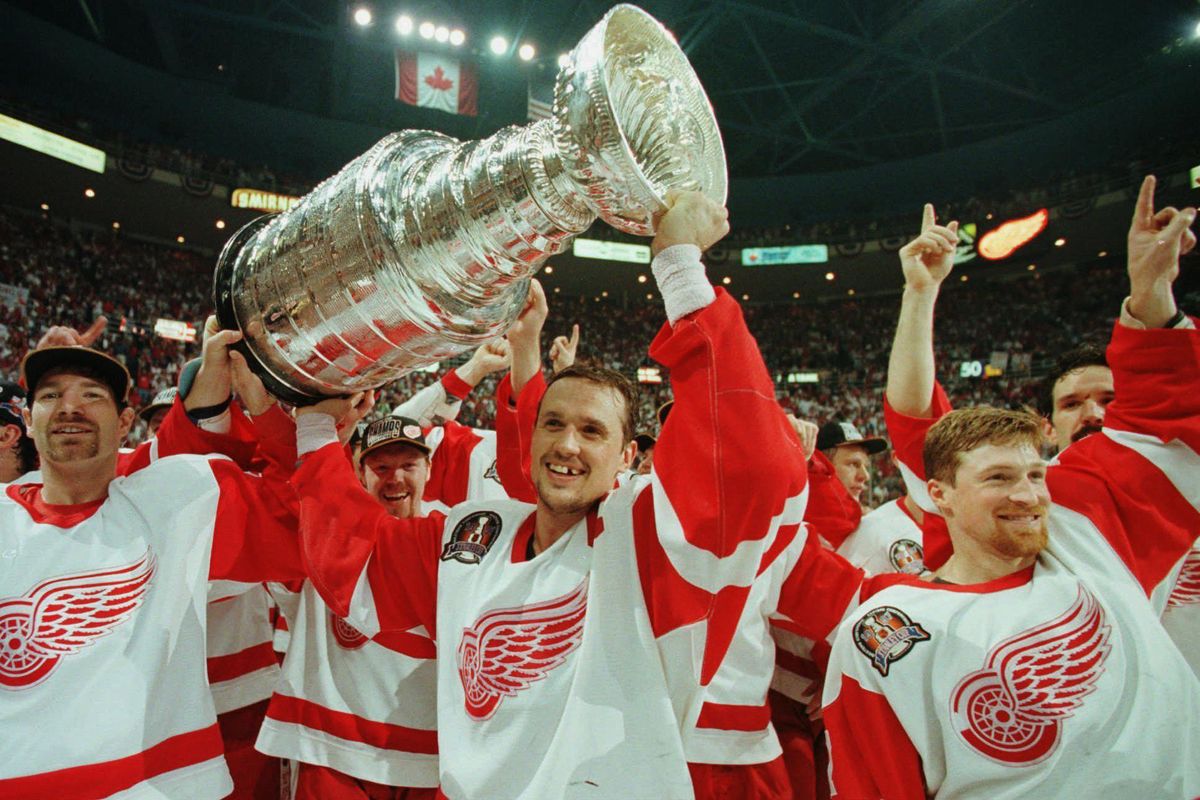 In this June 7, 1997, file photo, Detroit Red Wings’ Tim Taylor, from left, Steve Yzerman and Doug Brown celebrate with the Stanley Cup after beating the Philadelphia Flyers 2-1 at Joe Louis Arena in Detroit. Detroit swept the best-of-7 Stanley Cup final series against the Flyers, giving the franchise its first championship since 1955. The arena will be the home of the Red Wings one more time on Sunday, April 9, 2017, when they host the New Jersey Devils. (Tom Pidgeon / Associated Press)
