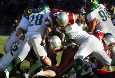 Washington State running back Jerome Harrison dives over the top of the pile for a touchdown against Oregon Saturday at Martin Stadium. Harrison finished with 117 yards on 14 carries.
(Christopher Anderson/ / The Spokesman-Review)
