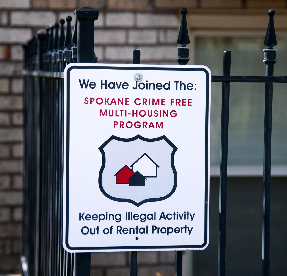 A Spokane Crime Free Multi-Housing sign is displayed at Kensington Court. (Dan Pelle / The Spokesman-Review)