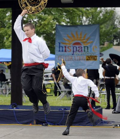 Adam, 16 and Daniel Cyr, 8, perform Saturday, Aug. 28 in Harmon Park as part of the annual Spokane Hispanic Heritage Festival.  (Dan Pelle)