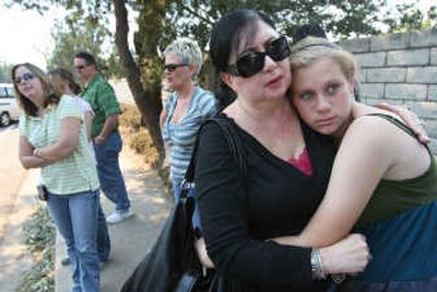 Sandy Sherman and daughter Alexa Sherman, 16, wait near a roadblock in Rancho Bernardo, Calif., on Wednesday. Associated Press
(Associated Press / The Spokesman-Review)