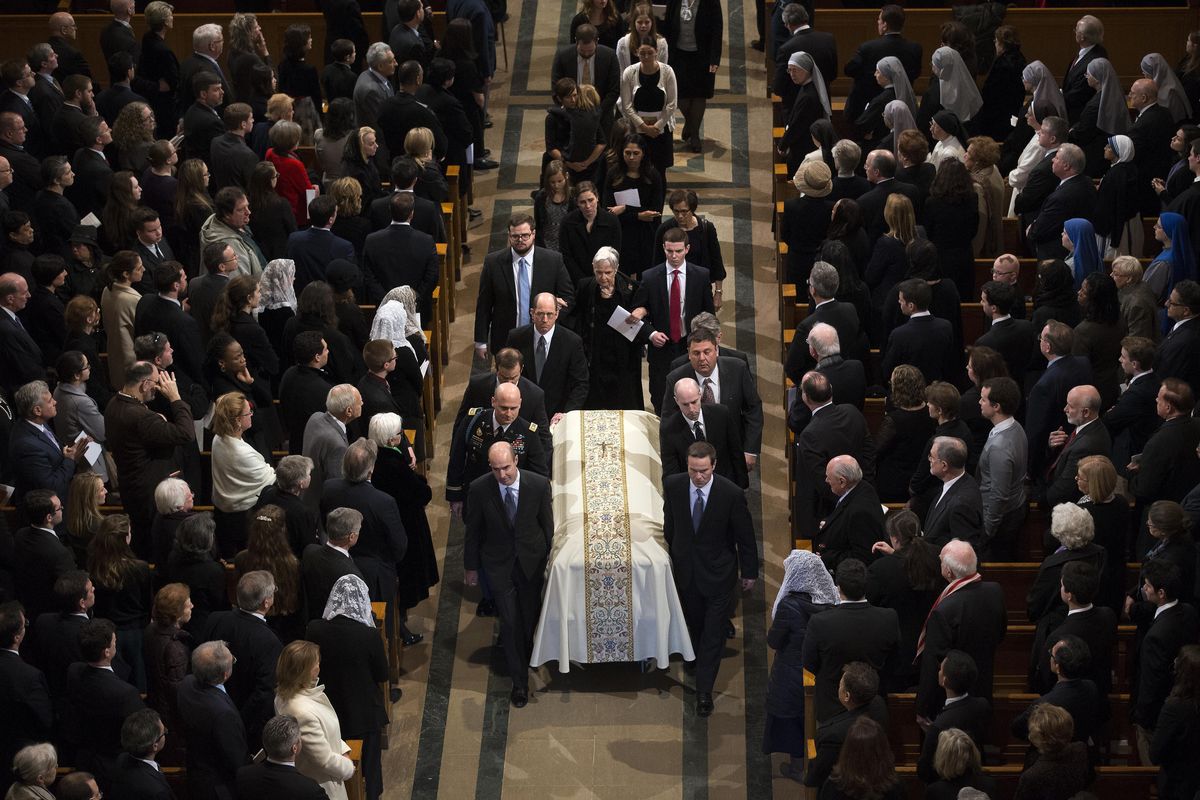 Widow Maureen McCarthy Scalia, walks behind the casket as it is ushered out of the Bascilica following the funeral mass for the late Supreme Court Associate Justice Antonin Scalia, at the Basilica of the National Shrine of the Immaculate Conception in Washington, Saturday, Feb. 20, 2016. (Doug Mills / Associated Press)