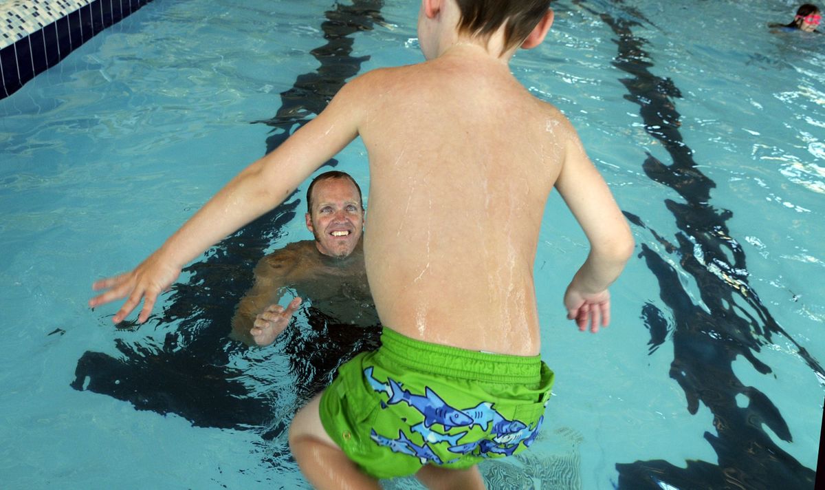 Sean Halsted catches his son Ethan, 5, at The Kroc Center in Coeur d’Alene on Tuesday. Halsted will compete in the National Veterans Wheelchair Games this week.  (Kathy Plonka / The Spokesman-Review)