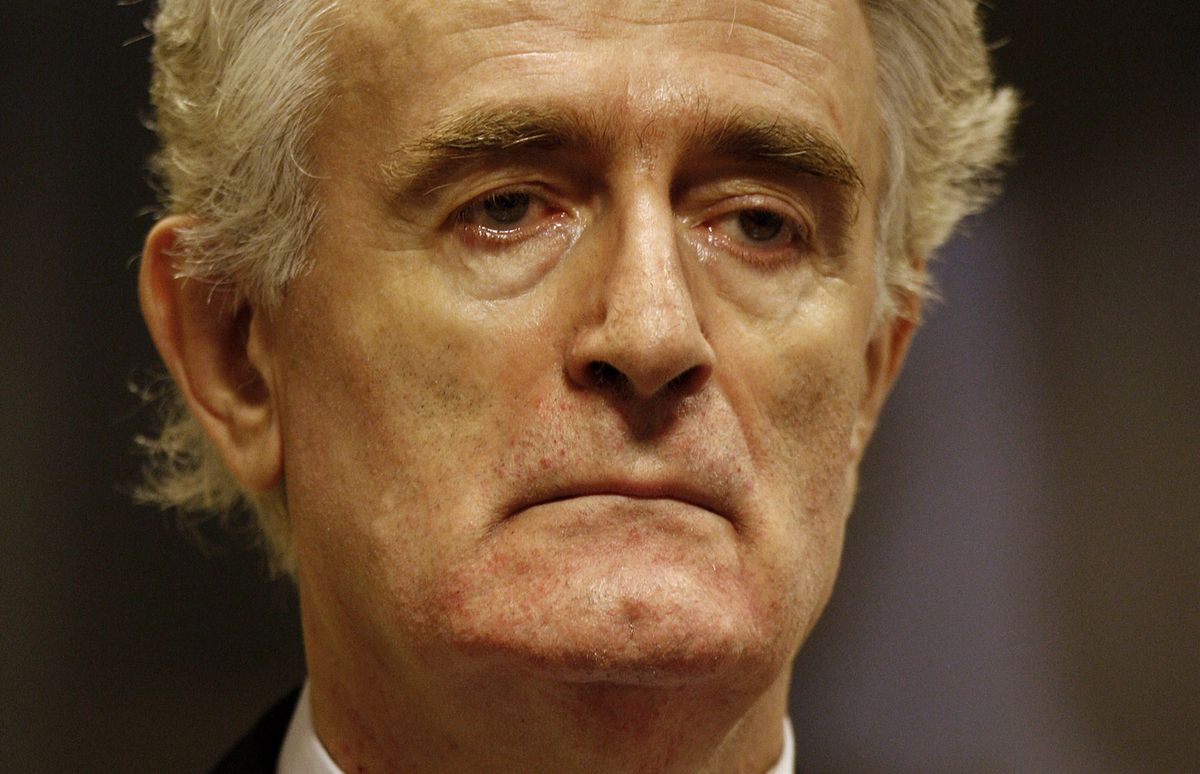 Former Bosnian Serb leader Radovan Karadzic stands in the courtroom during his initial appearance at the U.N.