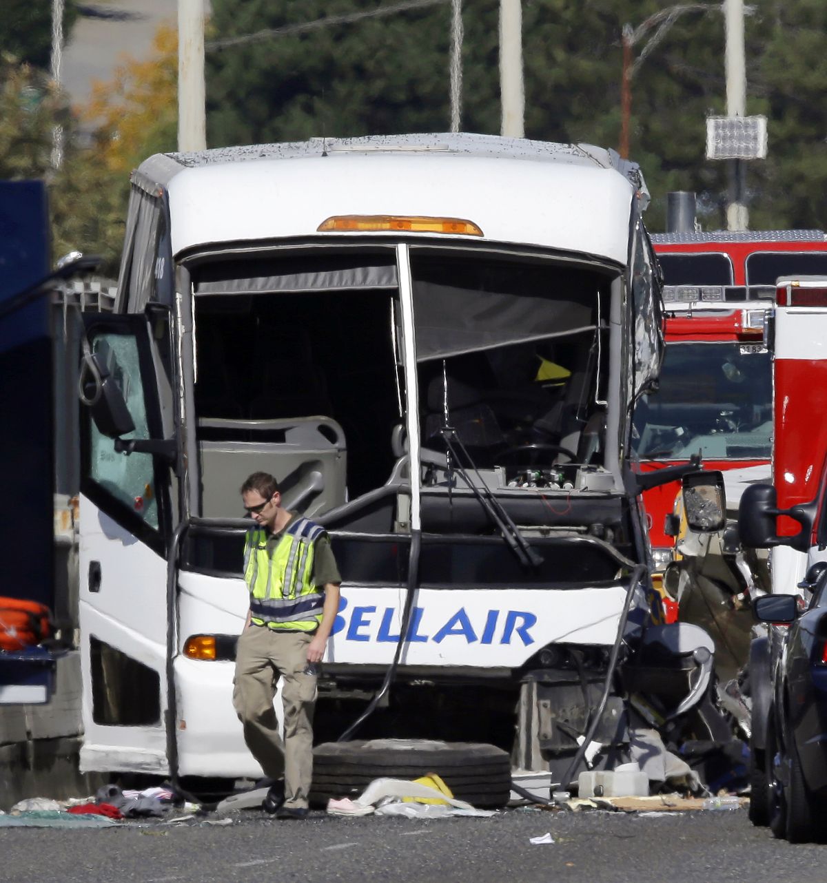 An emergency worker walks in front of a charter bus that was involved in a fatal crash with a "Ride the Ducks" amphibious tour bus, Thursday, Sept. 24, 2015, in Seattle. (Ted Warren / Associated Press)