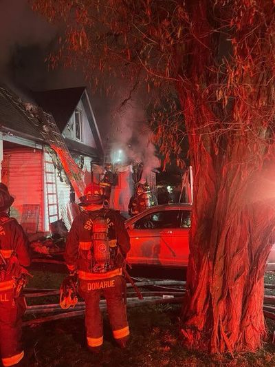 Firefighters extinguish a house fire Wednesday night in the Chief Garry Park Neighborhood. Rodney Barnhill was arrested on suspicion of first-degree arson and a court order violation.  (Courtesy of Spokane Fire Department)