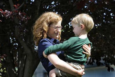 
Hannah Davis holds her 3-year-old son, Sam. Davis operates a parenting business called GarnetStar Coaching. 
 (CHRISTOPHER ANDERSON / The Spokesman-Review)