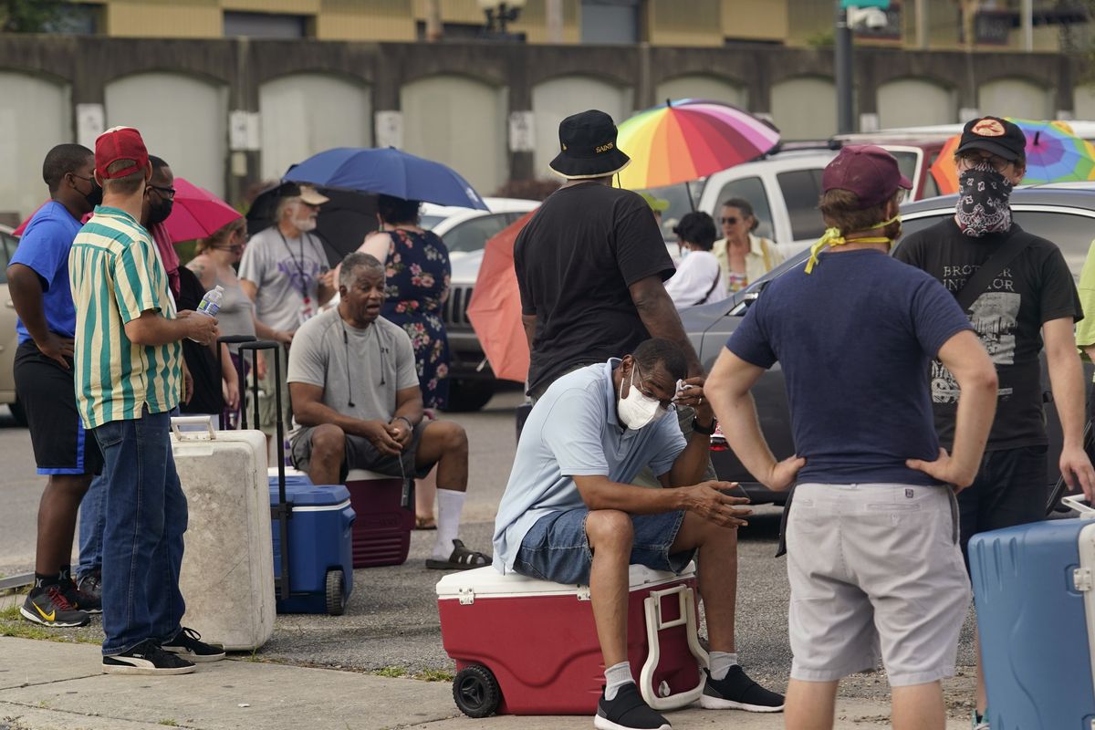 Louisiana residents still reeling from flooding and damage caused by Hurricane Ida are scrambling for food, gas, water and relief from the oppressive heat, Wednesday, Sept. 1, 2021, in New Orleans, La.  (Eric Gay)
