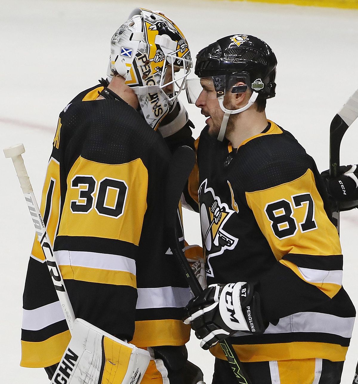Pittsburgh Penguins’ Sidney Crosby (87) congratulates goal tender Matt Murray (30) after a 7-0 shutout of the Philadelphia Flyers in Game 1 of an NHL first-round hockey playoff series in Pittsburgh, Wednesday, April 11, 2018. Crosby had his third career playoff hat trick in the game. (Gene J. Puskar / Associated Press)