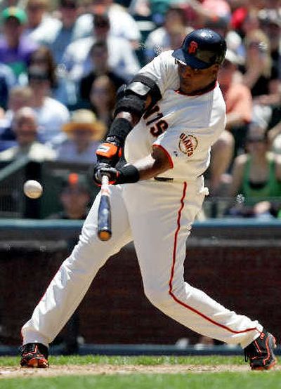 
Giants outfielder Barry Bonds connects off Rockies starter Byung-Hyun Kim in the fourth inning for his 715th career home run, passing Babe Ruth for second place on the all-time list. 
 (Associated Press / The Spokesman-Review)