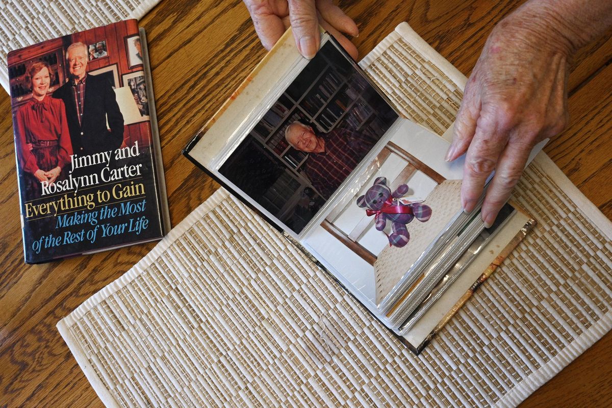 Nelle Ariail, who is a long-time friend of the Carters and has traveled around the world with them, shows photographs at her home, Monday, Feb. 20, 2023, in Plains, Ga.    (Hyosub Shin/The Atlanta Journal-Constitution/TNS)