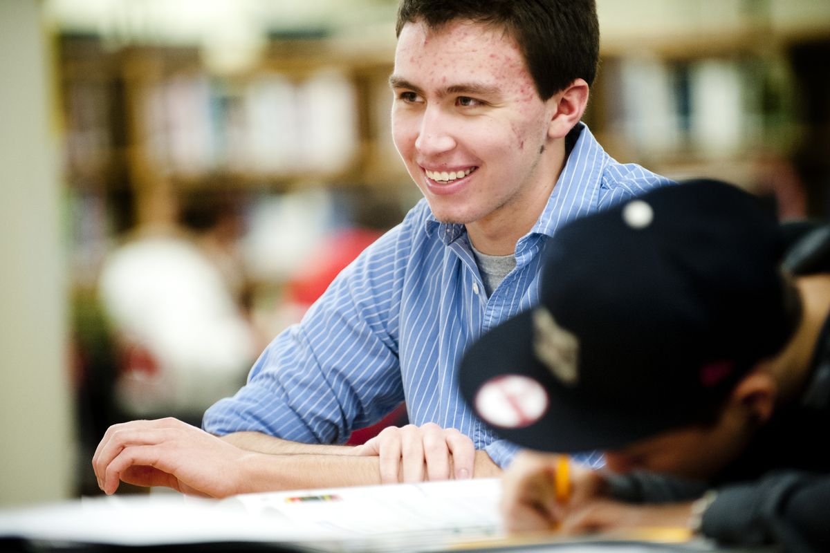 Forrest Ireland, a sophomore at Whitworth University, tutors North Central High School freshman Taylor Simpson on Dec. 12 at the high school. Ireland’s involvement in a successful DNA experiment at NC helped bring recognition to the school’s Institute of Science and Technology. (Tyler Tjomsland)