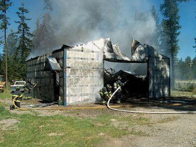 
Firefighters put out a fire inside a shed near Collins Road in Bayview on Sunday. The shed is owned by Will and Connie Collins.HERB HUSELAND
 (HERB HUSELAND / The Spokesman-Review)