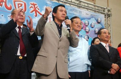 
Taiwan's Nationalist Party Chairman Ma Ying-jeou, center, delivers a victory speech at the party's headquarters as other leaders look on Saturday in Taipei. 
 (Associated Press / The Spokesman-Review)