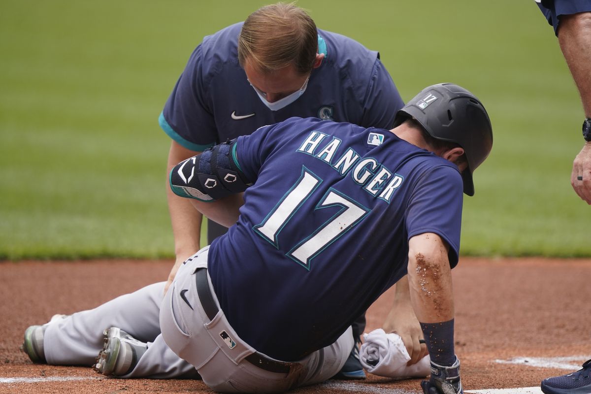 A trainer looks at Seattle Mariners