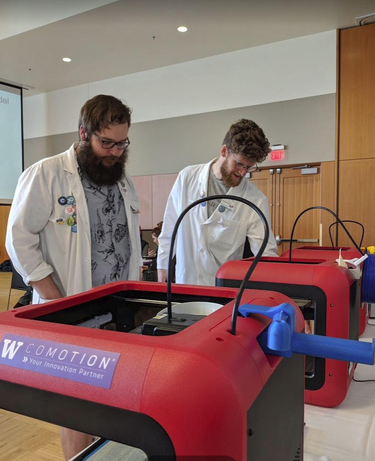 Scott Griffith and Daniel Mobley from Gonzaga’s Next Gen Tech Bar lead a laser-cutting demo on 3D printers at one of CoMotion @ Spokane’s events to promote innovation and entrepreneurship. (Courtesy University of Washington)