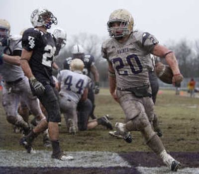 
Running back Gabe Le, right, scores one of his two touchdowns for Carroll College on Saturday. Associated Press
 (Associated Press / The Spokesman-Review)