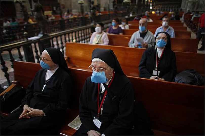 Nuns wear face masks during a closed door mass at the Metropolitan Cathedral in Mexico City on Sunday. Churches stood empty Sunday in predominantly Roman Catholic Mexico City after services were canceled, and health workers screened airports and bus stations for people sickened by a new strain of swine flu that experts fear could become a global epidemic.(AP Photo/Dario Lopez-Mills)
(April 26, 2009) (The Spokesman-Review)