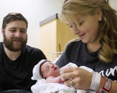 Selah and Luke Glendening look at their New Year’s baby, Elliot Archer Glendening, Sunday at Kootenai Health. (Loren Benoit/Coeur d'Alene Press)
