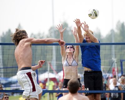 Taking a shot: Conner Moffatt, left, drives a ball at Haylee Mathis, center, and Eric Walker, right, at the annual Spike and Dig tournament Sunday at the Dwight Merkel Sports Complex in Spokane. More than 300 six-person teams played the two-day outdoor tournament in scorching heat. The tournament was founded in 1992. (Jesse Tinsley)