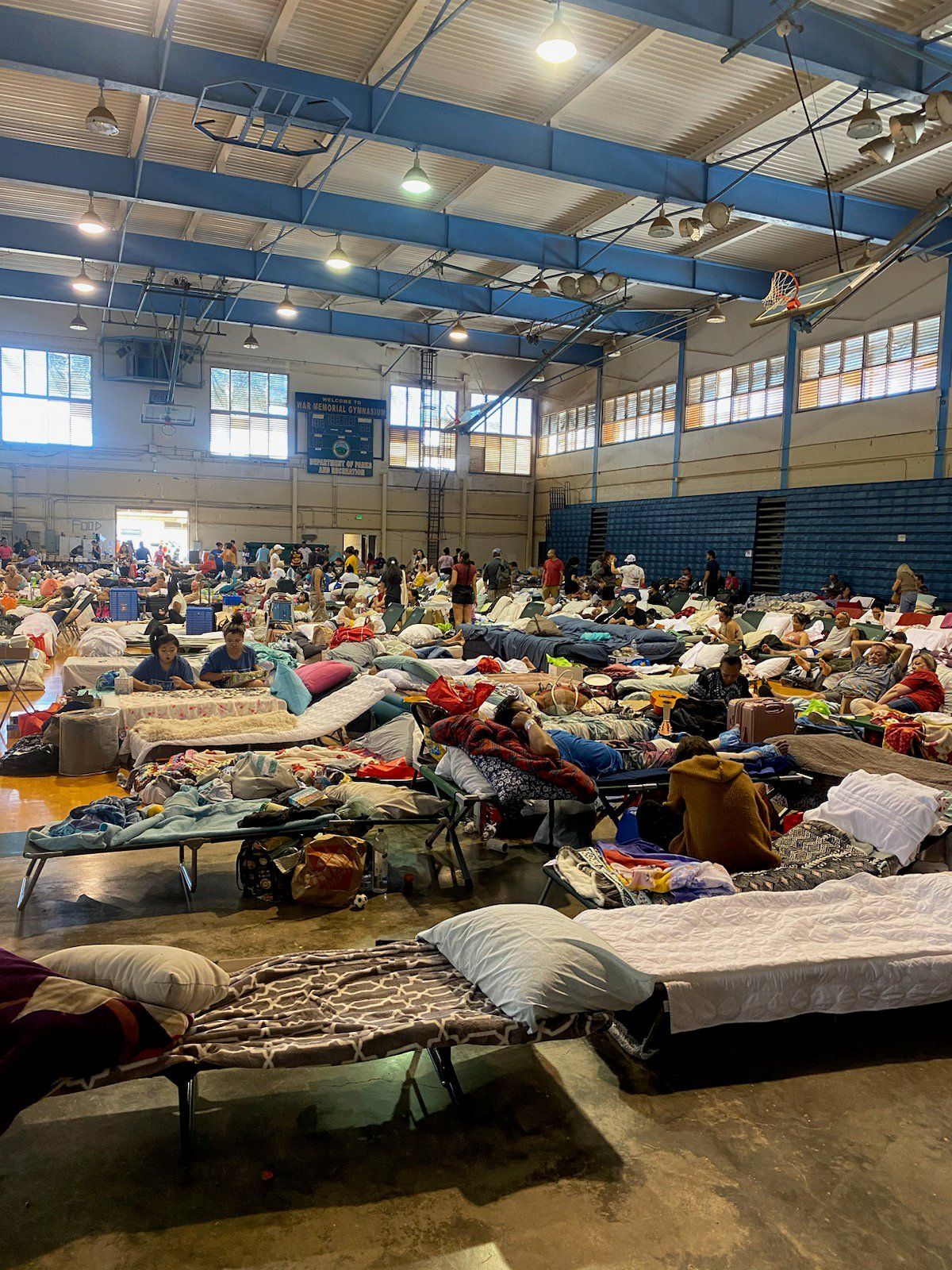 An evacuation center on Maui is filled with people who lost their homes in the island’s wildfires. Spokane’s Ryan Holbrook, a retired surgical oncologist, and his wife, Michele Holbrook, a semi-retired psychotherapist, are on the island now, helping victims of the fires.  (Chris Soprych / The Spokesman-Review)